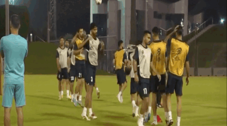 Screenshot from BBC News story featuring soccer players practicing on a field.